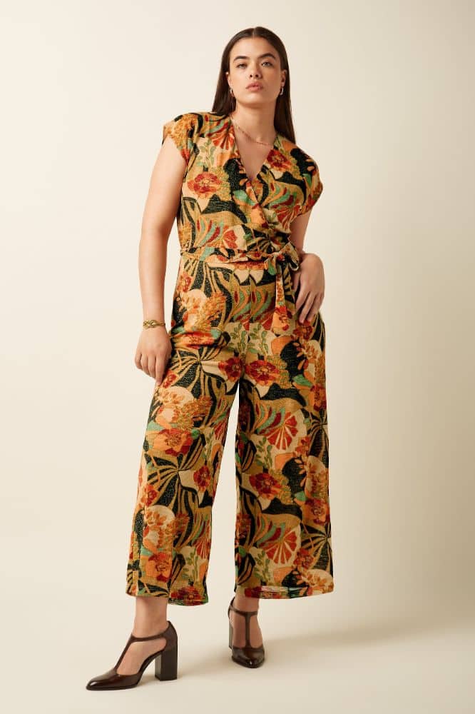 Mary Jumpsuit Dazz van King Louie – sprankelende jumpsuit met bloemenprint, overslagtop en cap sleeves. Comfortabel stretchmateriaal. Nu op lavieonline.nl.
