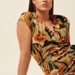 Mary Jumpsuit Dazz van King Louie – sprankelende jumpsuit met bloemenprint, overslagtop en cap sleeves. Comfortabel stretchmateriaal. Nu op lavieonline.nl.